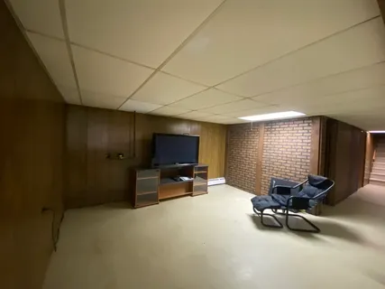 a view of a livingroom with workspace and a window