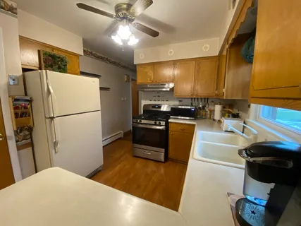 a kitchen with a refrigerator and a sink