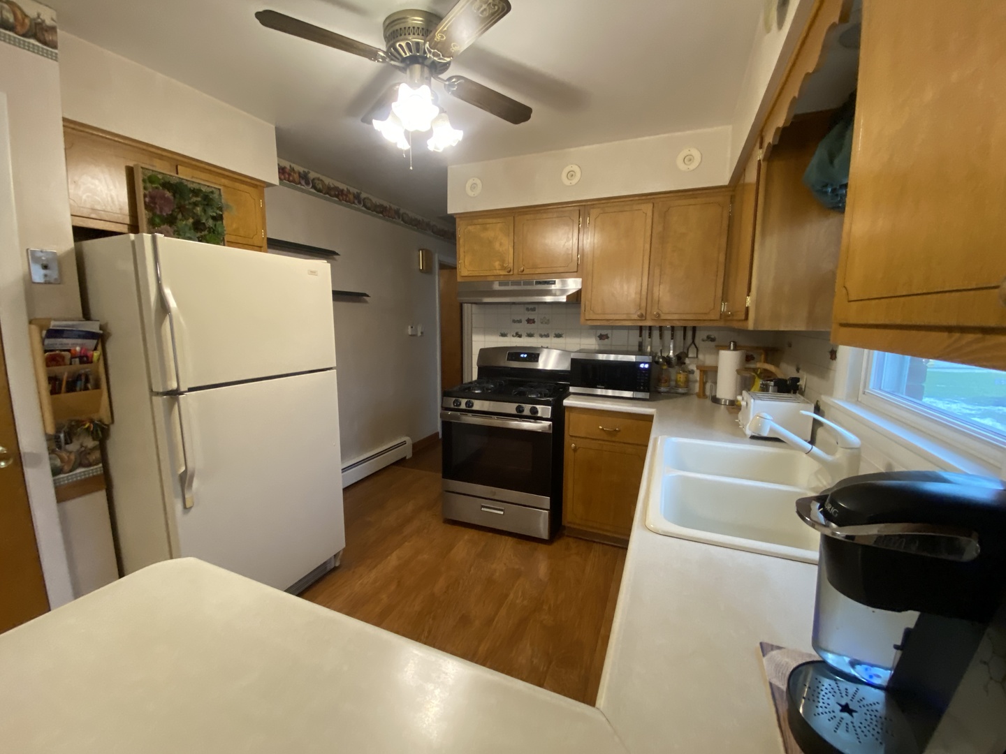 2050 Atwood Avenue Berkeley, IL 60163 - Photo 4 of 23 a kitchen with a refrigerator and a sink