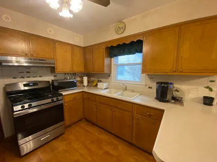 a kitchen with a sink appliances and cabinets