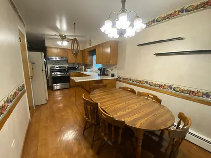 a view of a dining room with furniture and a chandelier