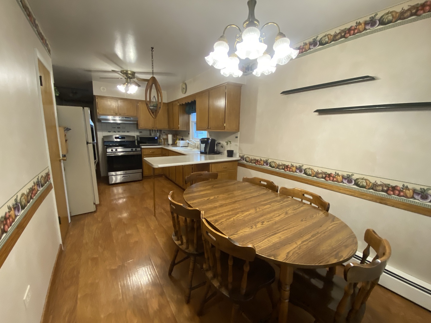 2050 Atwood Avenue Berkeley, IL 60163 - Photo 7 of 23 a view of a dining room with furniture and a chandelier