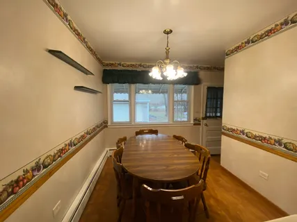 a view of a dining room with furniture and chandelier