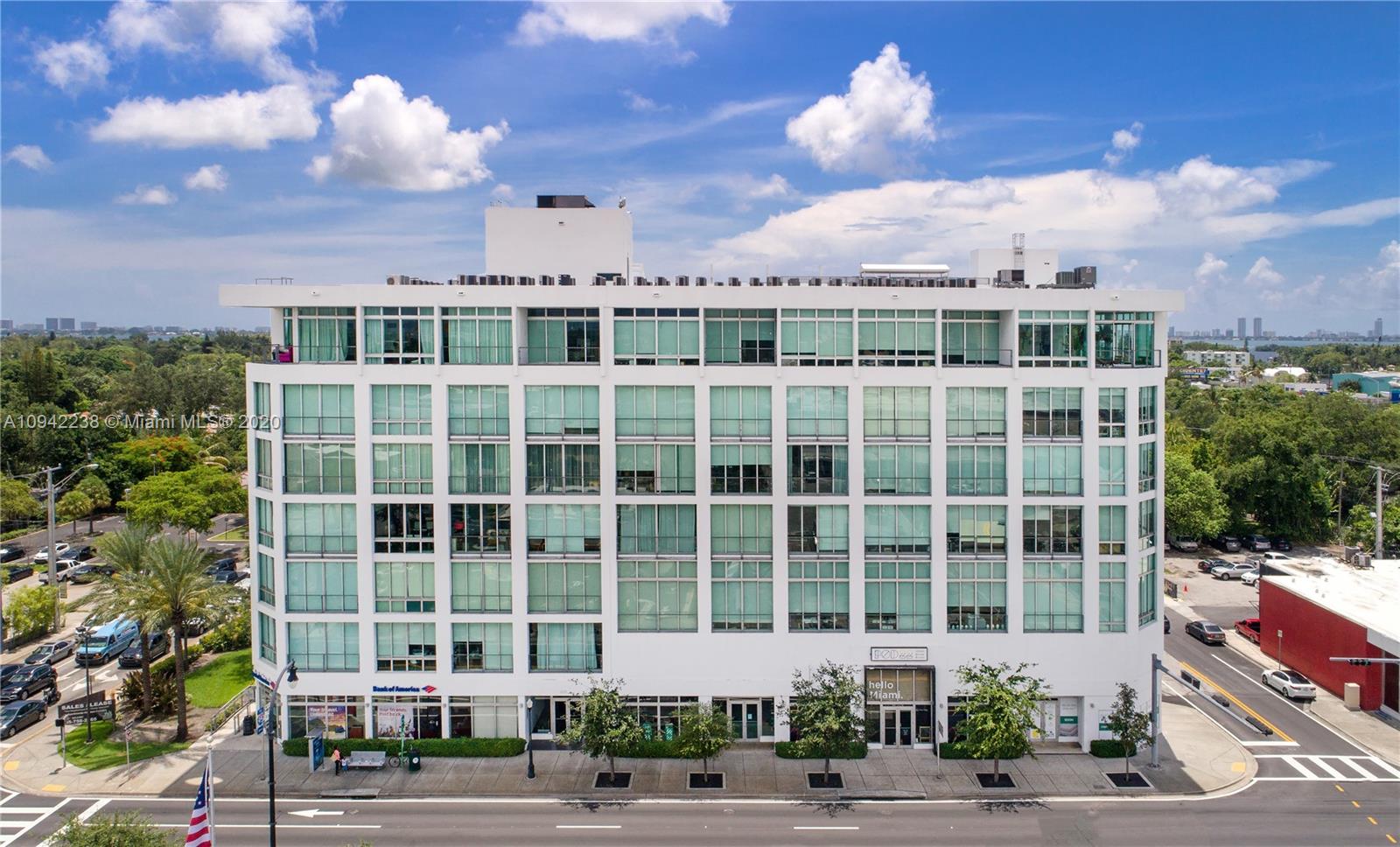 8101 Biscayne Boulevard, Unit R705 Miami, FL 33138 - Photo 19 of 32 a view of a building with a garden and pathway