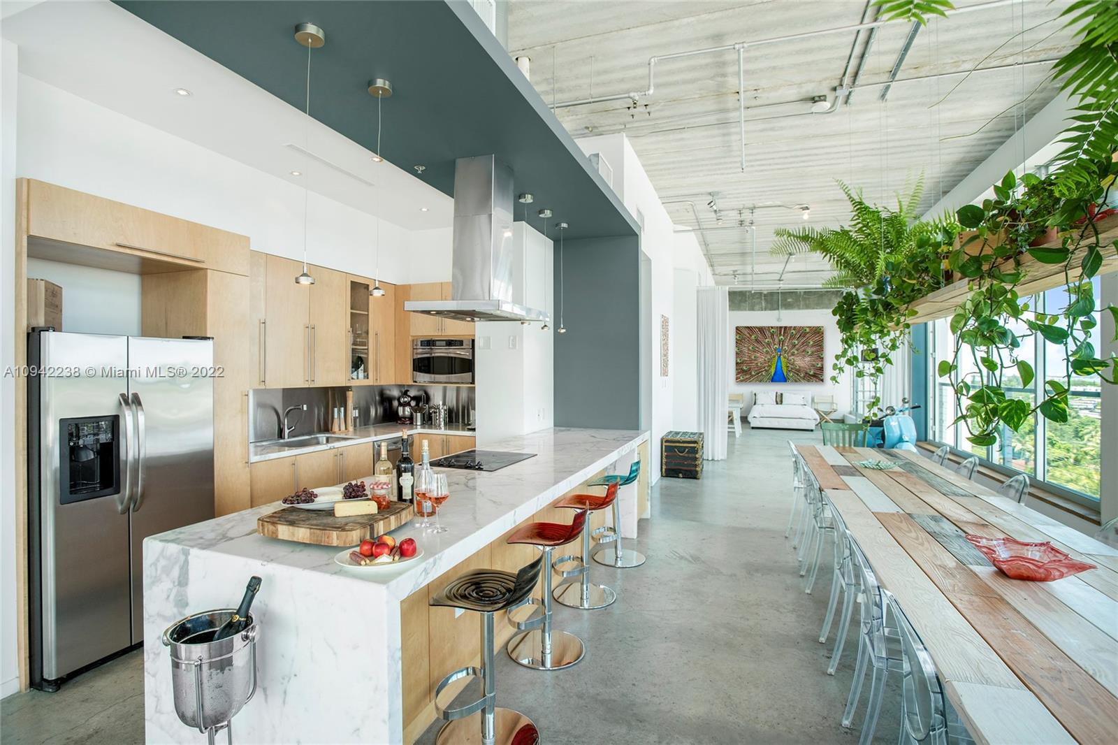 8101 Biscayne Boulevard, Unit R705 Miami, FL 33138 - Photo 3 of 32 a open kitchen with stainless steel appliances kitchen island granite countertop a refrigerator a stove a sink a dining table and chairs with the potted plants