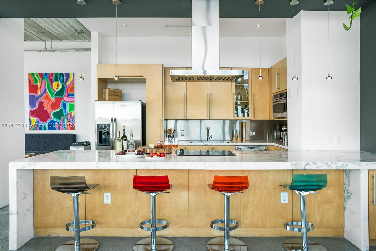8101 Biscayne Boulevard, Unit R705 Miami, FL 33138 - Photo 4 of 32 a kitchen with stainless steel appliances kitchen island granite countertop a refrigerator and a stove
