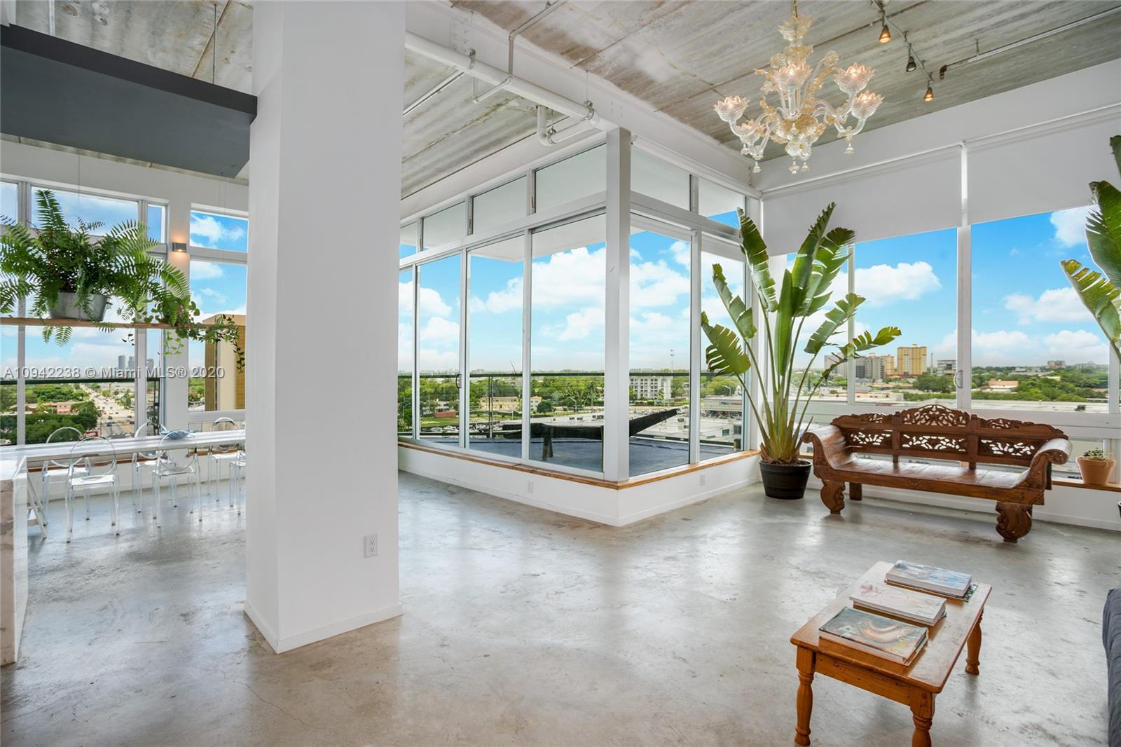 8101 Biscayne Boulevard, Unit R705 Miami, FL 33138 - Photo 5 of 32 a view of a livingroom with furniture and a potted plant