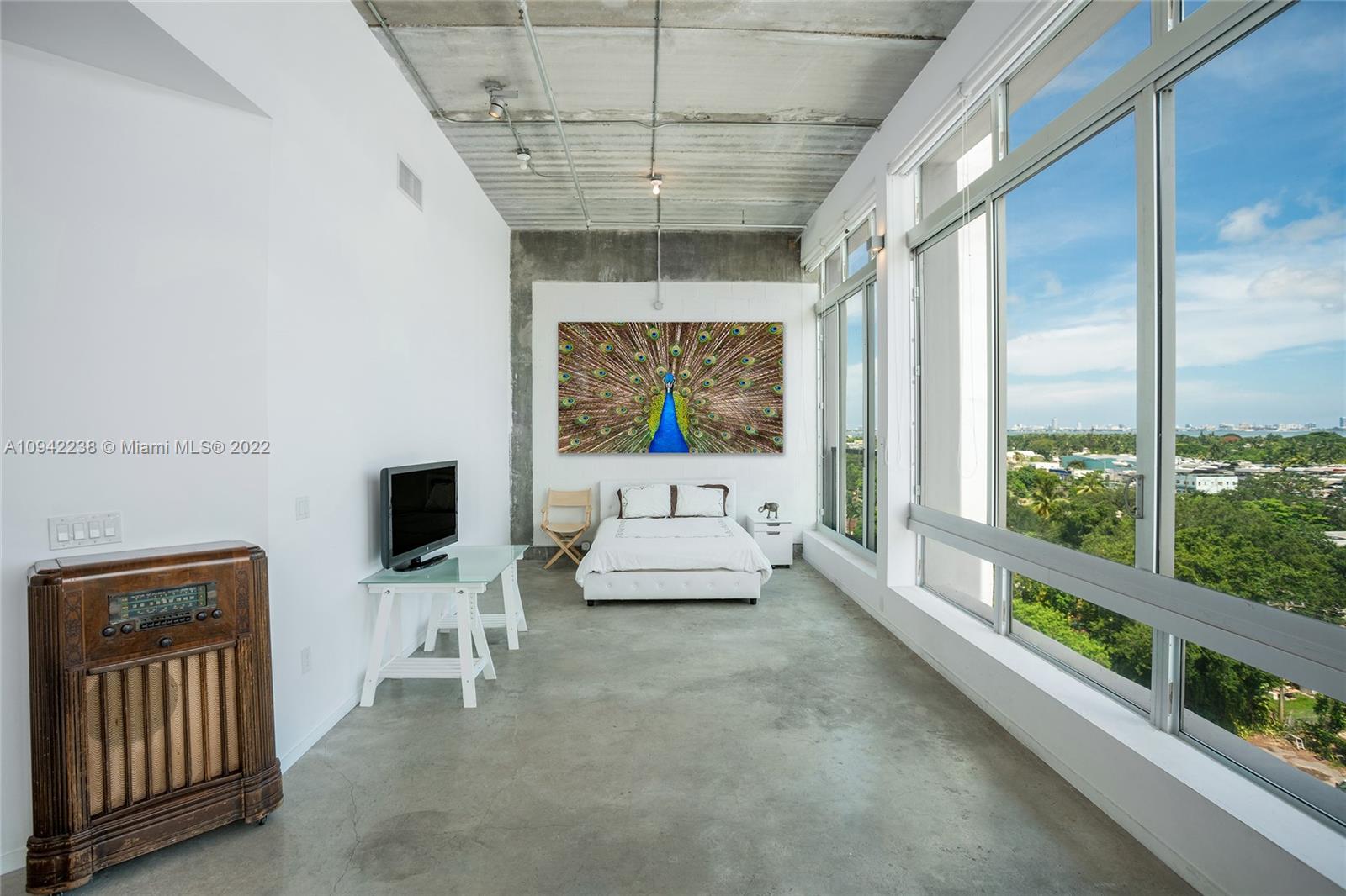 8101 Biscayne Boulevard, Unit R705 Miami, FL 33138 - Photo 8 of 32 a living room with furniture and a flat screen tv