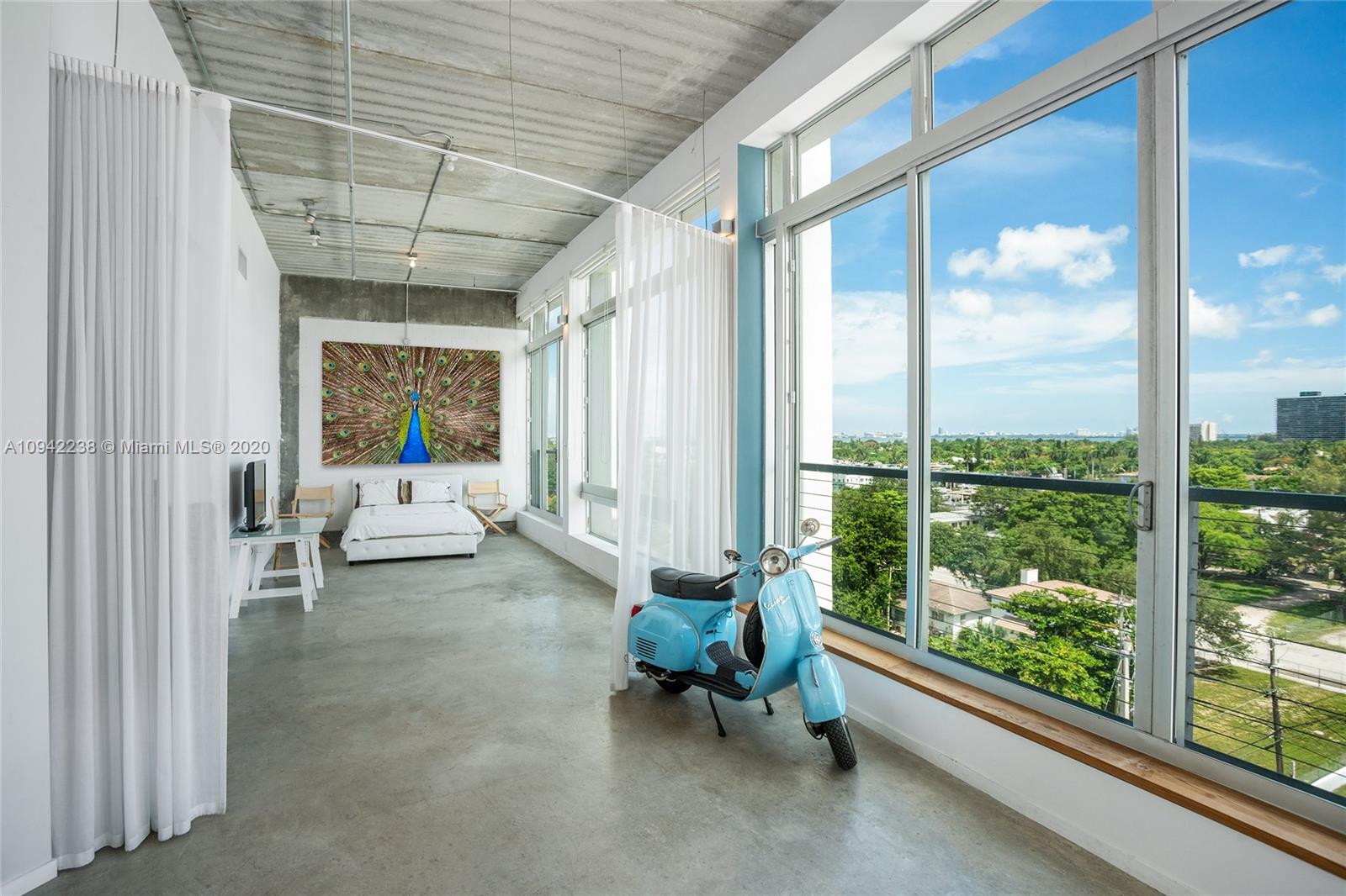 8101 Biscayne Boulevard, Unit R705 Miami, FL 33138 - Photo 9 of 32 a living room with furniture and a large window