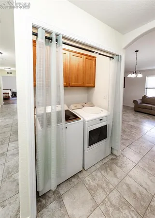 a view of a kitchen with a sink and a refrigerator