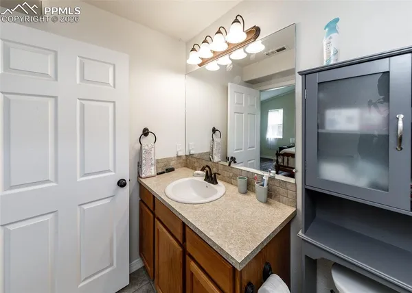 a bathroom with a sink vanity and a mirror