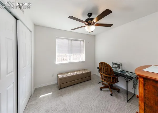 a view of workspace with a window and a ceiling fan