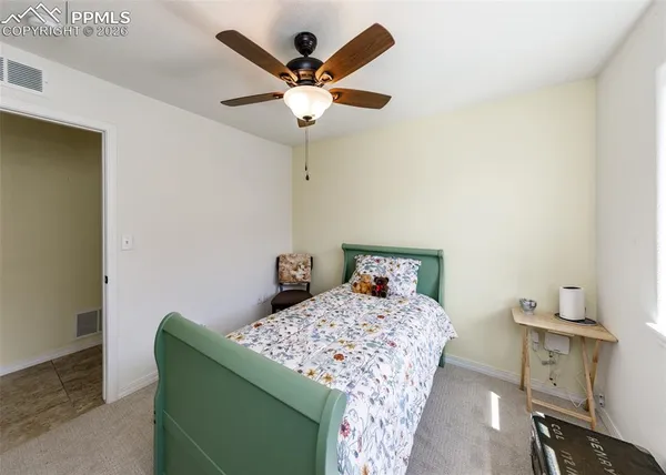a bedroom with a bed and a table in it