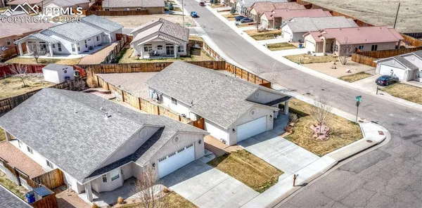 an aerial view of a house with large trees