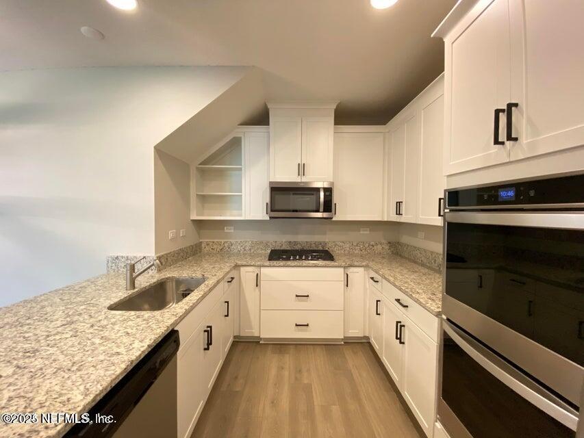 534 Pine Bluff Drive St. Augustine, FL 32092 - Photo 11 of 30 a kitchen with granite countertop white cabinets and white appliances