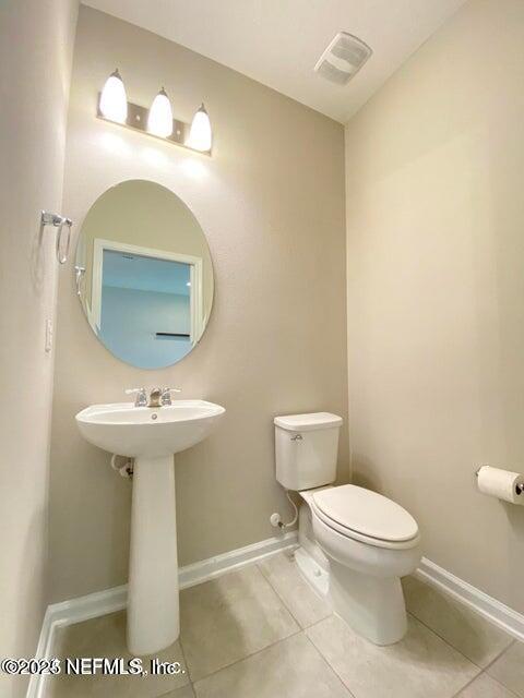 534 Pine Bluff Drive St. Augustine, FL 32092 - Photo 15 of 30 a bathroom with a sink a toilet and mirror