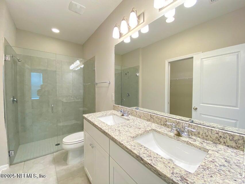 534 Pine Bluff Drive St. Augustine, FL 32092 - Photo 20 of 30 a bathroom with a granite countertop sink a toilet a mirror and shower