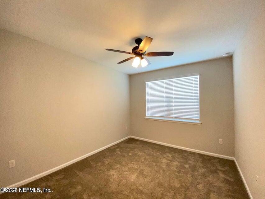 534 Pine Bluff Drive St. Augustine, FL 32092 - Photo 21 of 30 a view of a room with a ceiling fan and a window