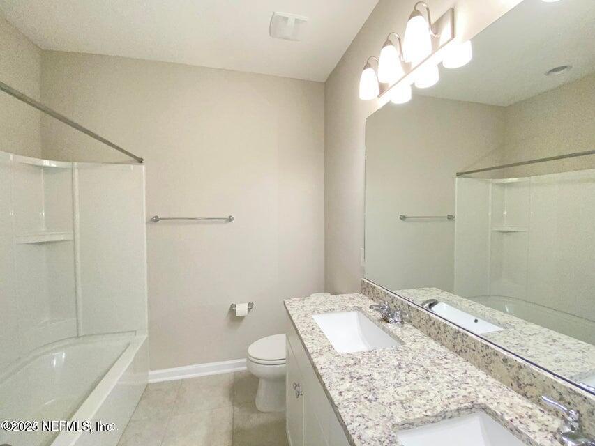 534 Pine Bluff Drive St. Augustine, FL 32092 - Photo 24 of 30 a bathroom with a granite countertop sink a toilet and shower
