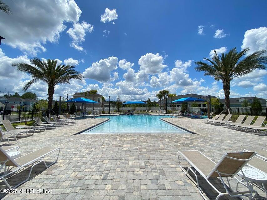 534 Pine Bluff Drive St. Augustine, FL 32092 - Photo 27 of 30 a view of a swimming pool with a chair and tables