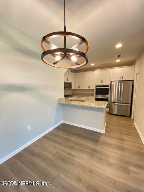 534 Pine Bluff Drive St. Augustine, FL 32092 - Photo 9 of 30 a view of kitchen with stainless steel appliances granite countertop counter top space and cabinets