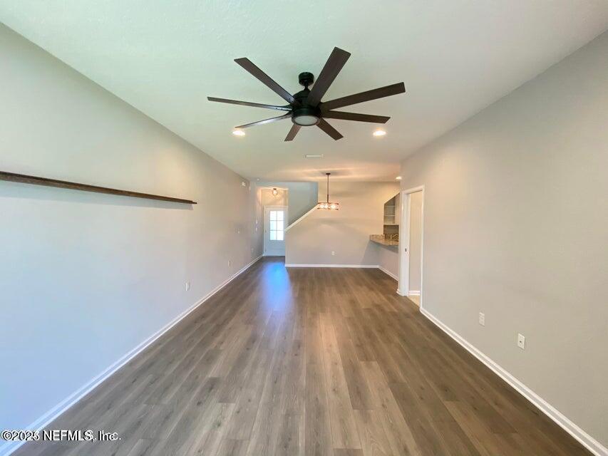 534 Pine Bluff Drive St. Augustine, FL 32092 - Photo 10 of 30 a view of a big room with wooden floor and a ceiling fan