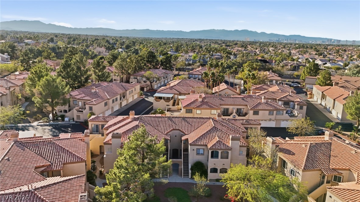 Aerial view of residential area featuring a mountainous background