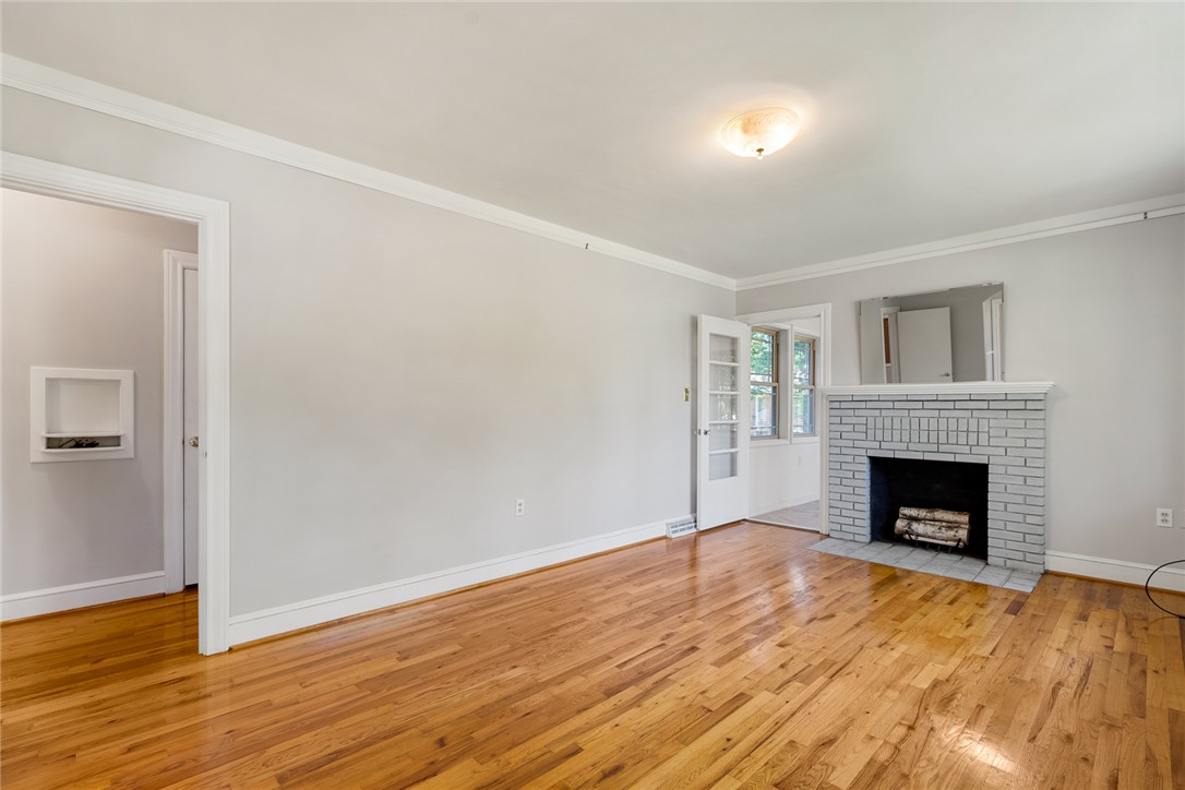 1509 869 Anderson, SC 29621 - Photo 6 of 45 Hardwood flooring extends throughout this versatile living area, featuring a cozy fireplace.