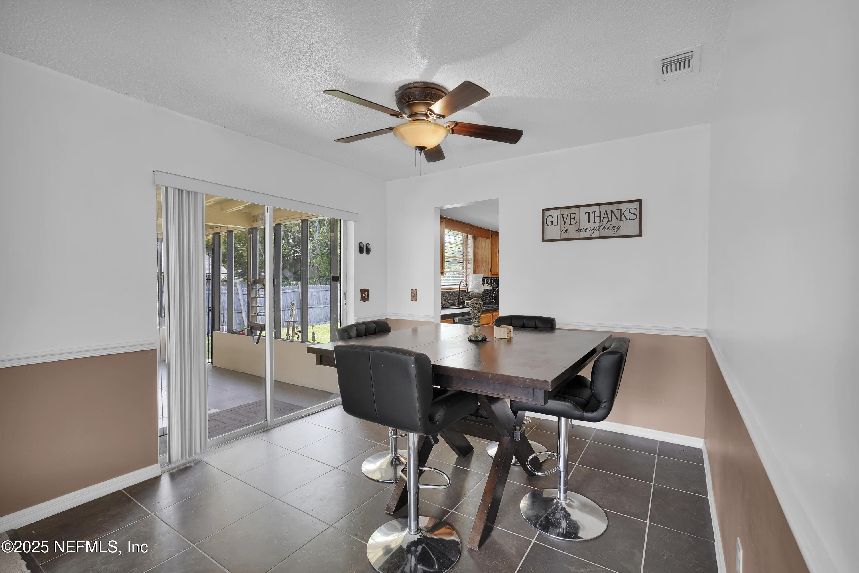 1610 Derringer Road Jacksonville, FL 32225 - Photo 11 of 29 a view of a dining room with furniture and chandelier