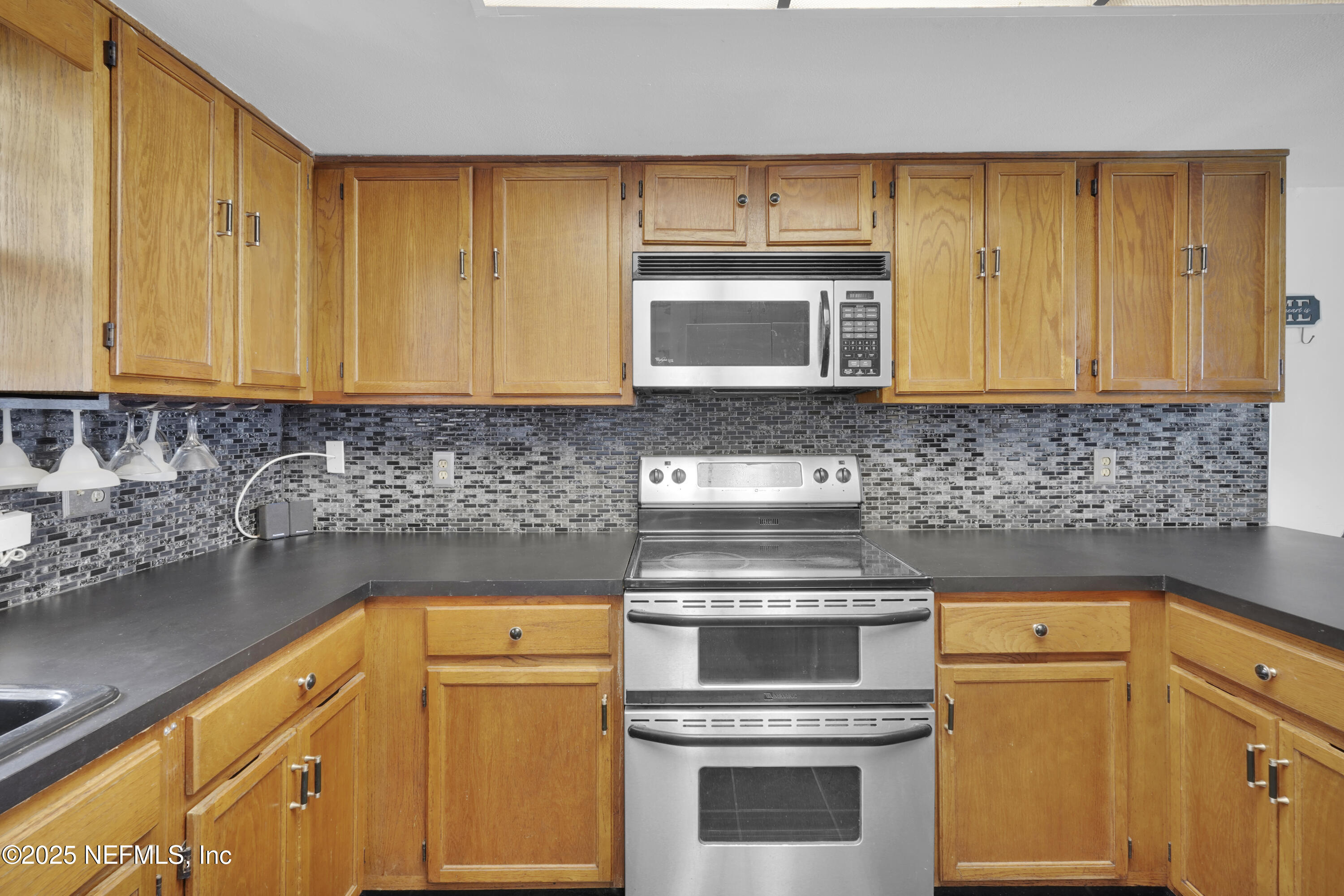 1610 Derringer Road Jacksonville, FL 32225 - Photo 15 of 29 a kitchen with a stove microwave and sink