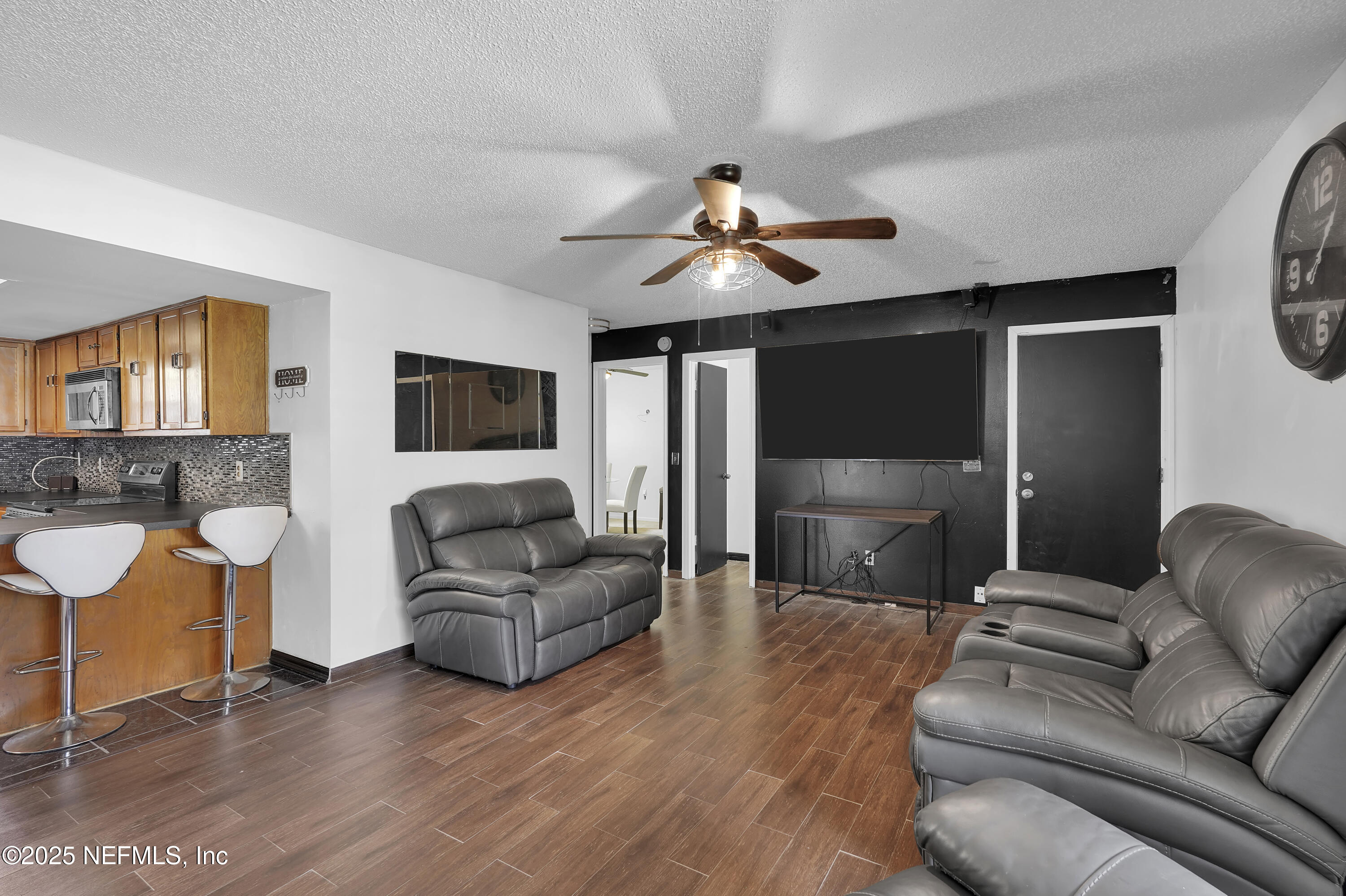 1610 Derringer Road Jacksonville, FL 32225 - Photo 16 of 29 a living room with furniture and a flat screen tv