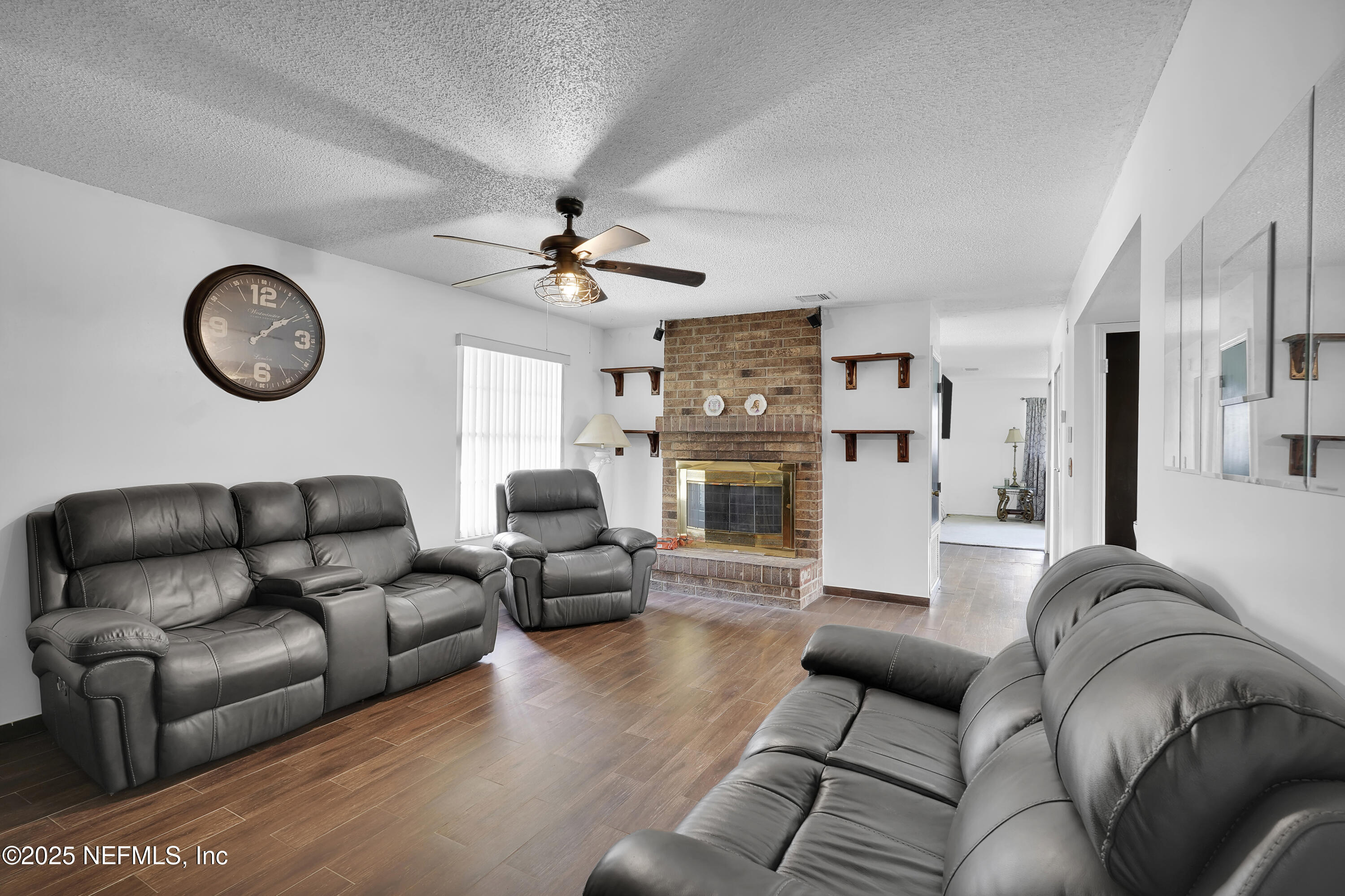 1610 Derringer Road Jacksonville, FL 32225 - Photo 17 of 29 a living room with furniture a clock on wall and a table