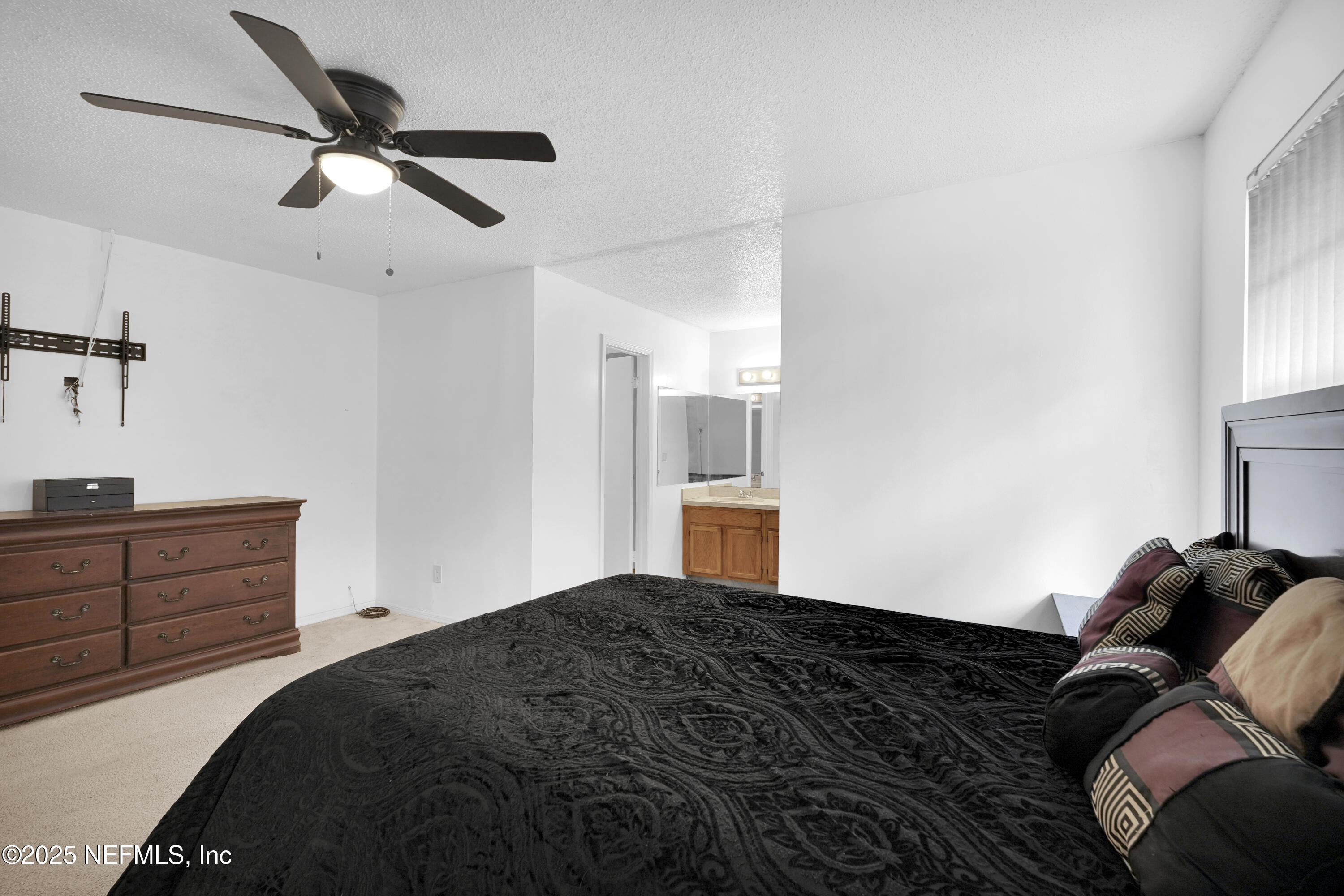 1610 Derringer Road Jacksonville, FL 32225 - Photo 20 of 29 a bedroom with a bed and a ceiling fan