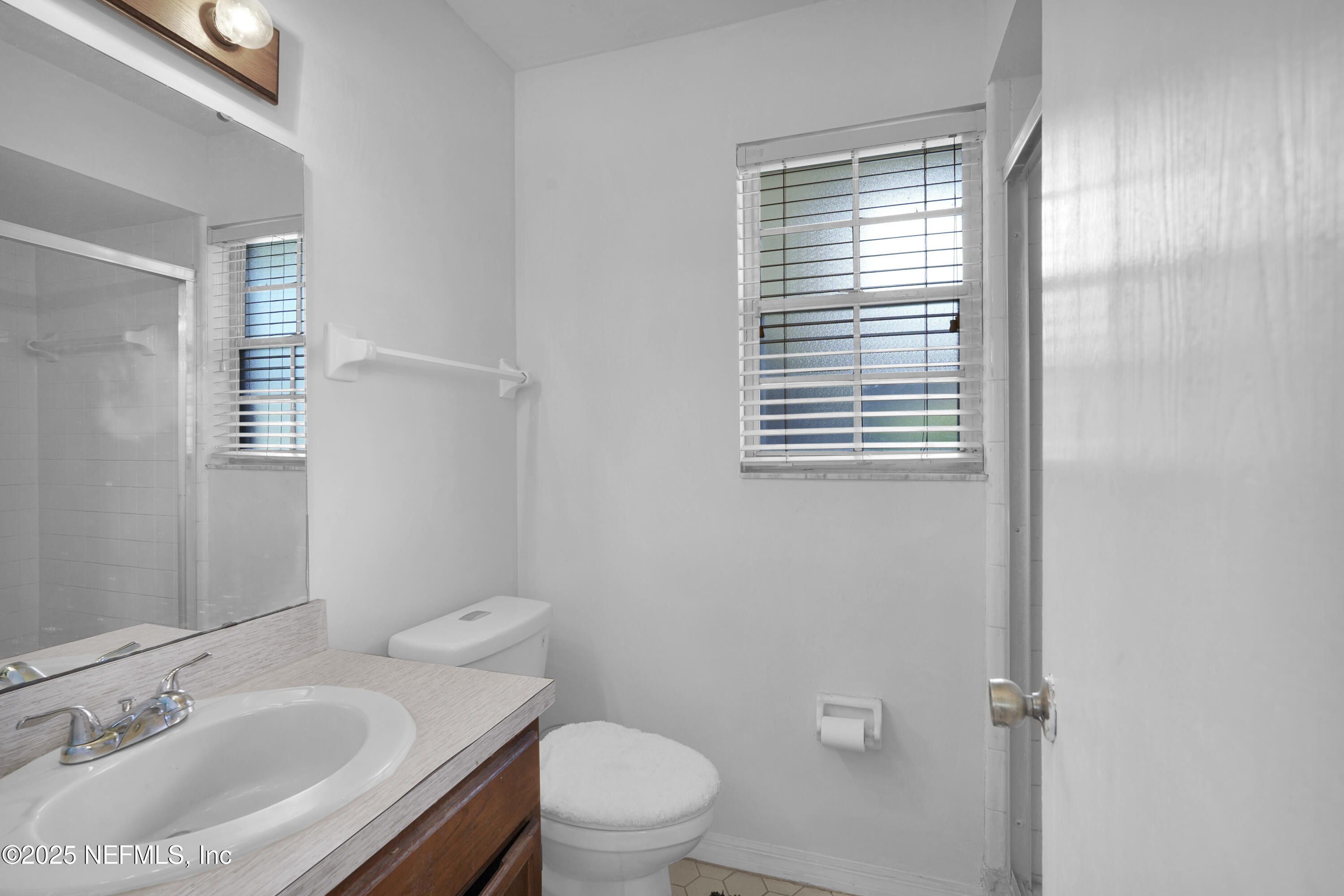 1610 Derringer Road Jacksonville, FL 32225 - Photo 22 of 29 a bathroom with a sink toilet and a mirror