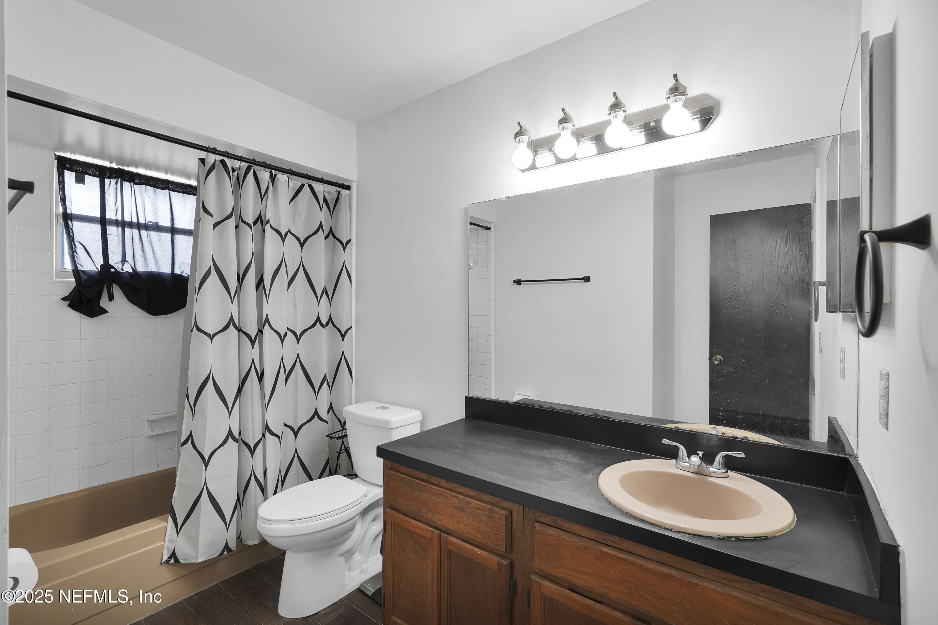 1610 Derringer Road Jacksonville, FL 32225 - Photo 26 of 29 a bathroom with a granite countertop sink toilet a mirror and shower curtain