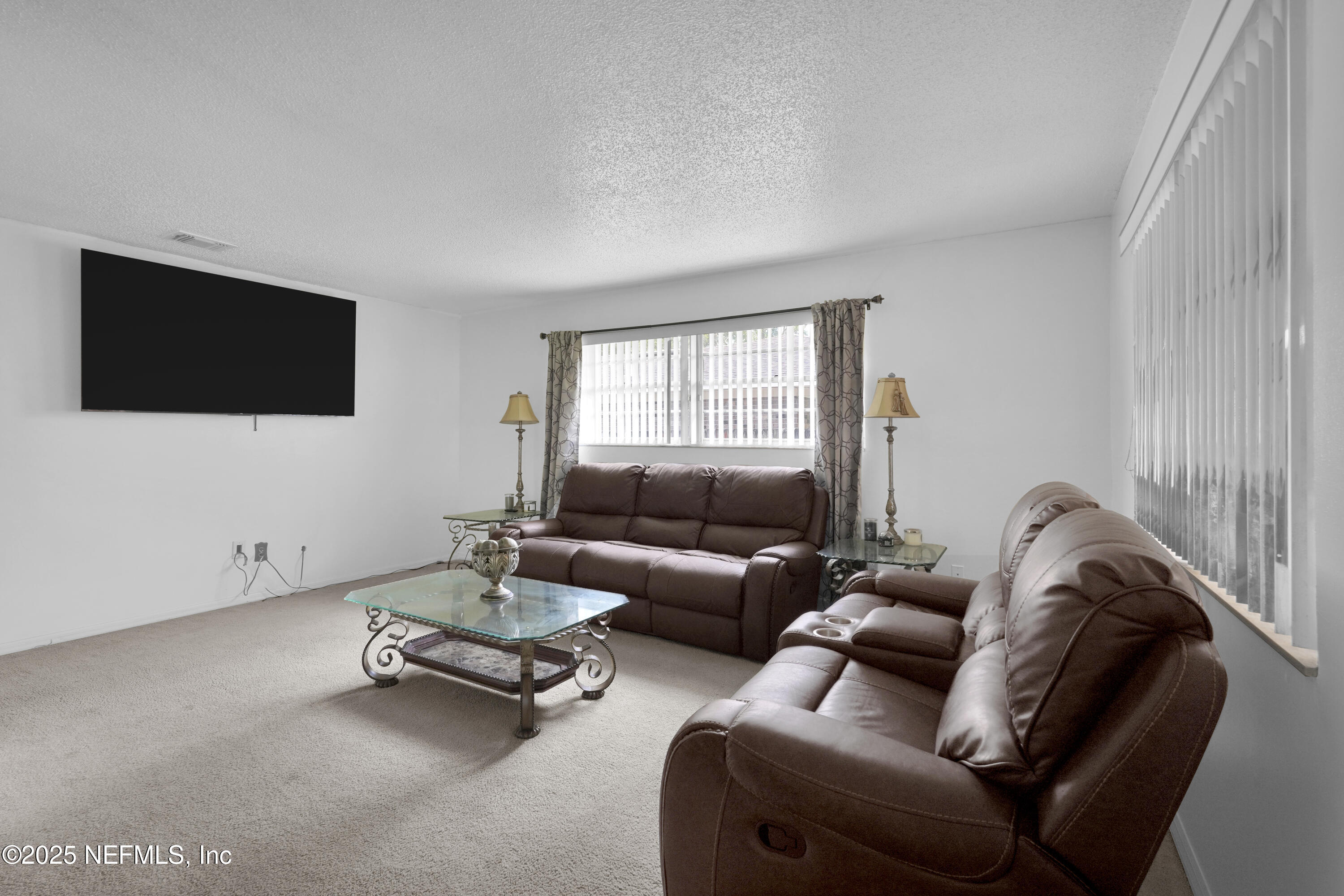1610 Derringer Road Jacksonville, FL 32225 - Photo 7 of 29 a living room with furniture and a flat screen tv