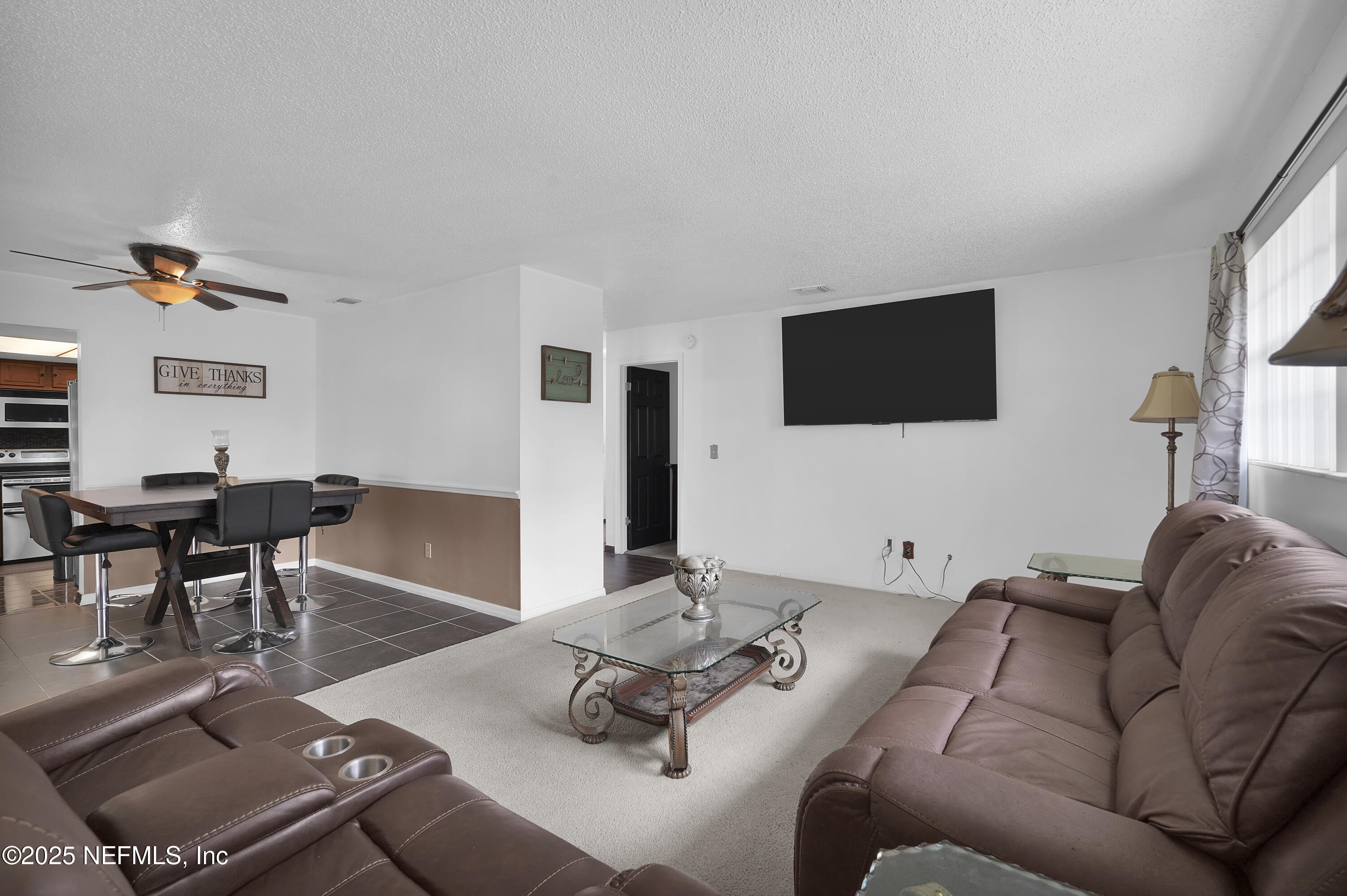 1610 Derringer Road Jacksonville, FL 32225 - Photo 8 of 29 a living room with furniture and a flat screen tv