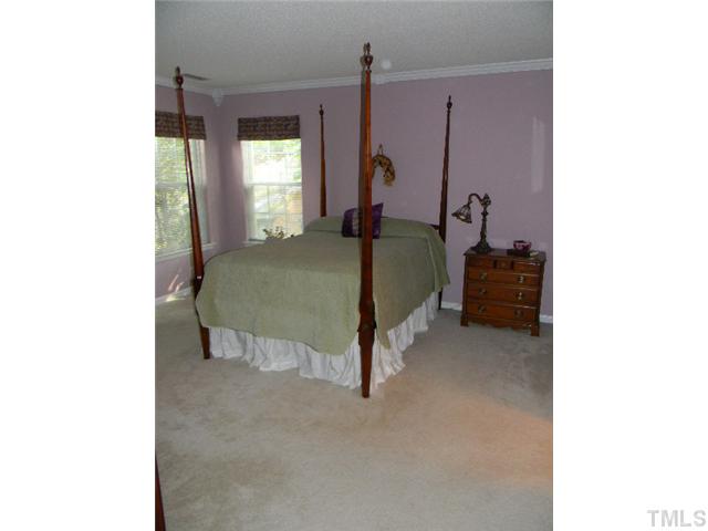 5028 Silverdene Street Raleigh, NC 27616 - Photo 14 of 25 Spacious master bedroom sits on the back side of the home and overlooks the back and side yards...tons of space, accentuated crown molding and walk in closet make this the perfect retreat after a long day!