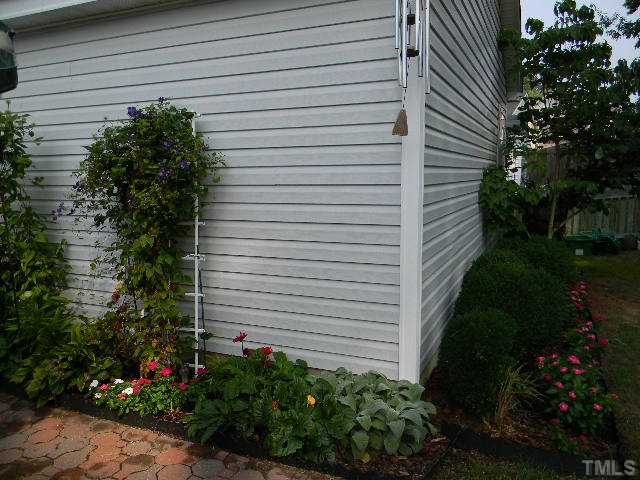 5028 Silverdene Street Raleigh, NC 27616 - Photo 19 of 25 Stunning flower gardens wrap around the back of the home