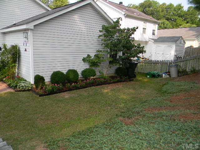 5028 Silverdene Street Raleigh, NC 27616 - Photo 21 of 25 The side of the lower level of your back yard with great level grassy areas - fencing wraps entire yard and is gated on either side of the home for easy access