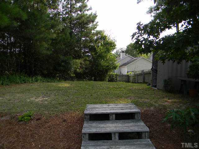 5028 Silverdene Street Raleigh, NC 27616 - Photo 23 of 25 The upper level of your yard is both wooded and open and features a detached storage unit (which will convey with the property)