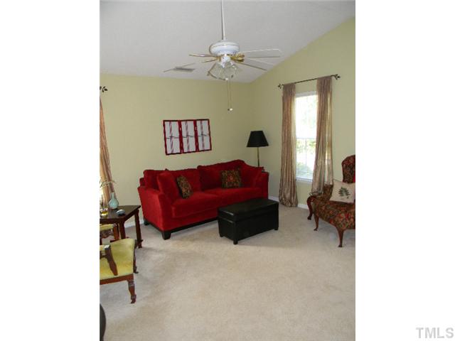 5028 Silverdene Street Raleigh, NC 27616 - Photo 3 of 25 Spacious living room with vaulted ceiling, tons of natural light and ceiling fan