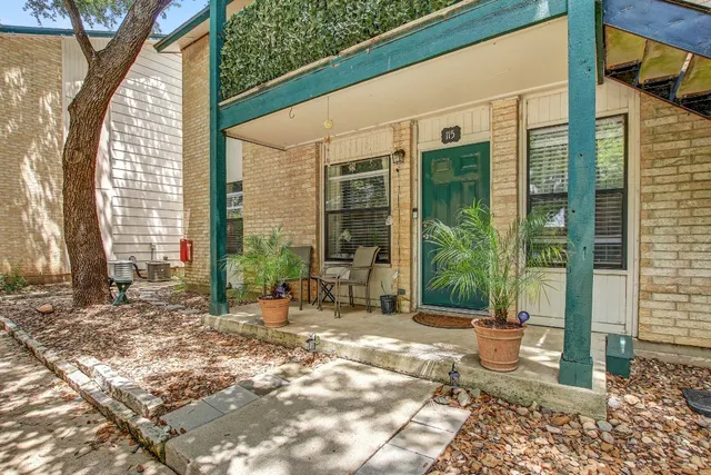 a view of a back yard of the house and a chair