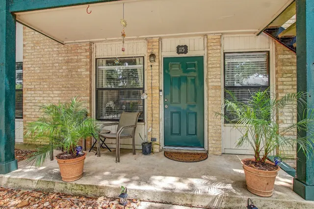 a view of a balcony with chair and potted plants