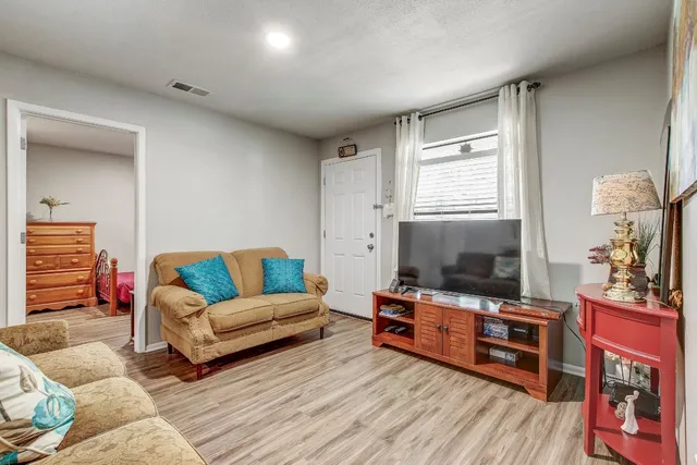 a living room with furniture and a flat screen tv