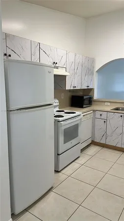 a kitchen with stainless steel appliances a sink and cabinets