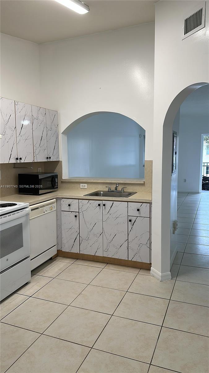 2910 Southeast 12th Road, Unit 20429 Homestead, FL 33035 - Photo 13 of 25 a kitchen with stainless steel appliances a sink and cabinets