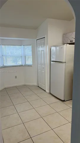 an empty room with wooden floor & closet