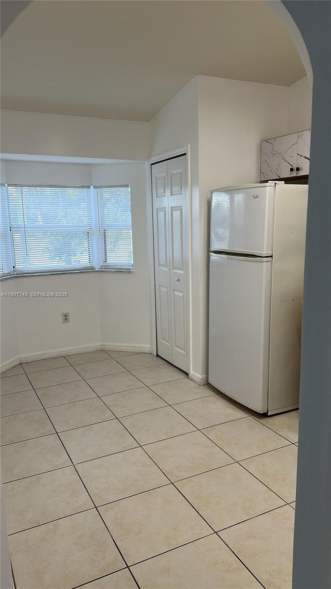 2910 Southeast 12th Road, Unit 20429 Homestead, FL 33035 - Photo 14 of 25 a view of a kitchen with a refrigerator and cabinets