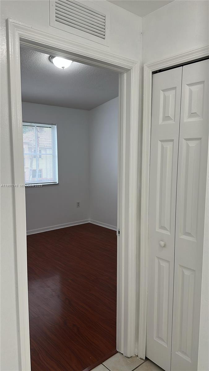 2910 Southeast 12th Road, Unit 20429 Homestead, FL 33035 - Photo 17 of 25 a view of an empty room with wooden floor and closet